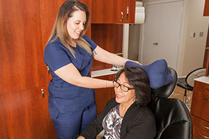 Dental Assistant providing a patient with a comfortable pillow.